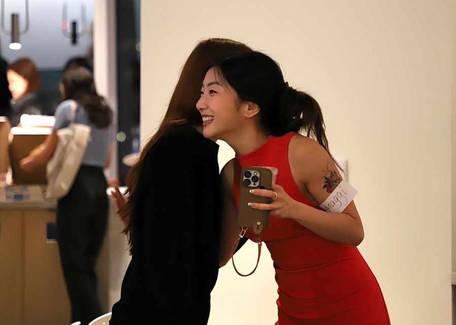 Maggi hugging a guest at a gathering