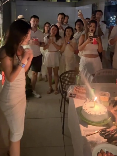 Friends gathered round a birthday cake